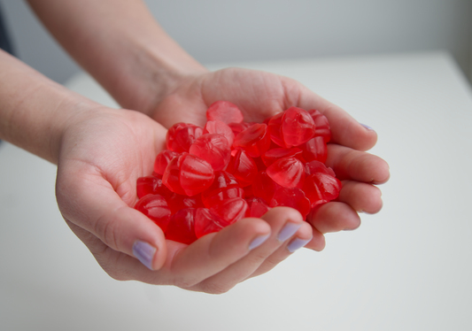 A huge handful of strawberry flavoured creatine gummies